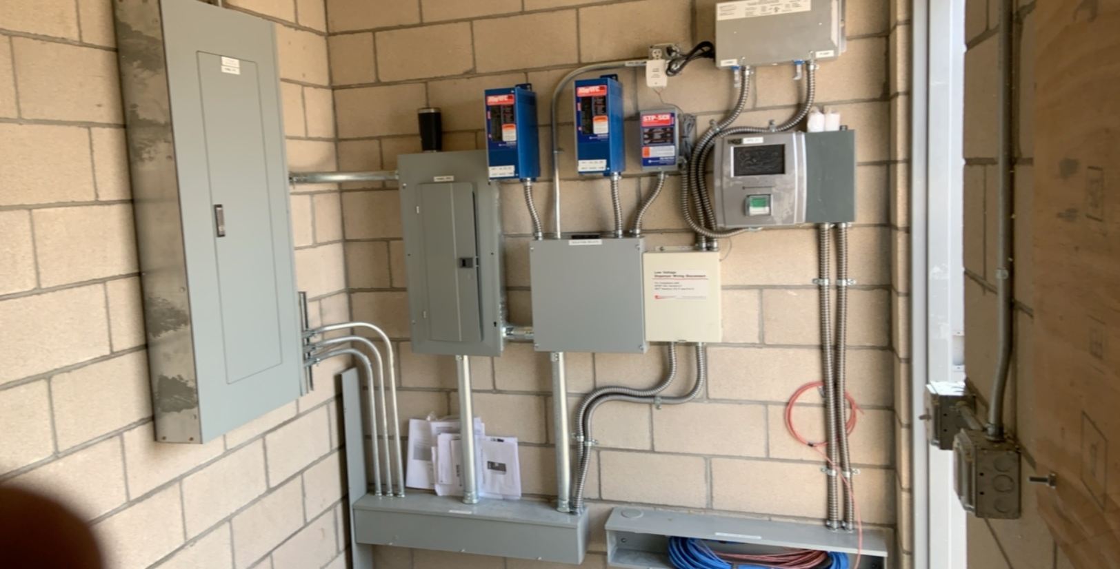 Wide view of a commercial equipment room with multiple electrical panels