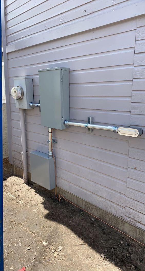 Exterior electrical meter and panel mounted on a home